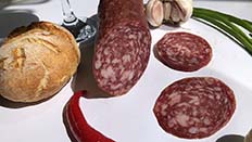 Salchichón is a large diameter and quite long dry sausage, usually stuffed into pork bung or suitable artificial casings.